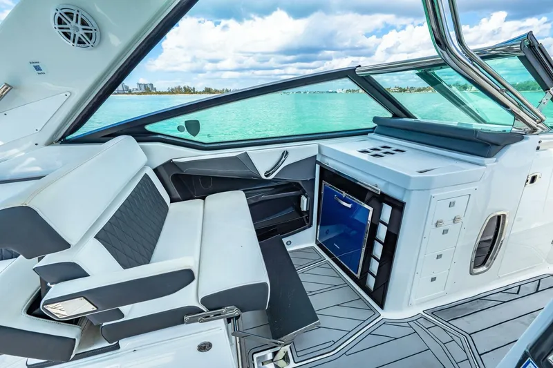Slide: The Image of 2023 Monterey 350 Sport Yacht interior with sleek seating and modern amenities, overlooking turquoise waters. - 17