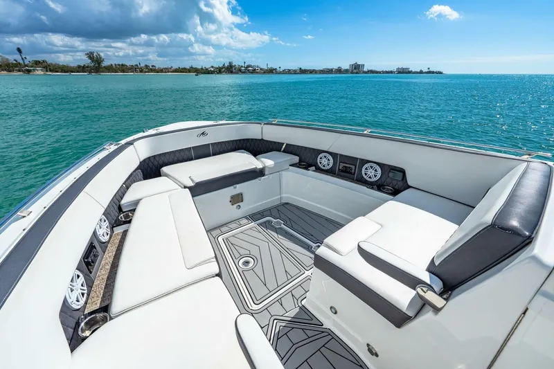 Slide: The Image of 2023 Monterey 350 Sport Yacht interior with luxurious seating, overlooking serene blue waters. - 23