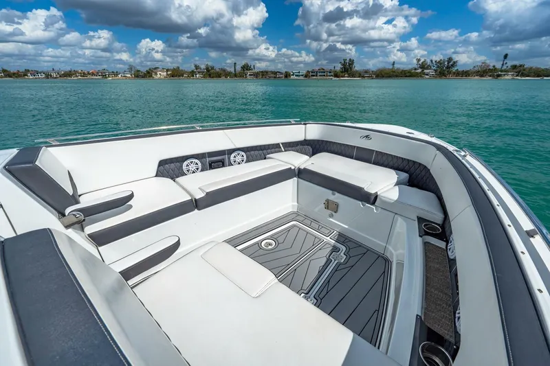 Slide: The Image of 2023 Monterey 350 Sport Yacht interior with luxurious seating on calm waters. - 24