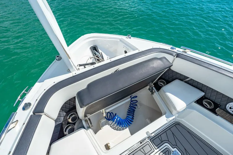 Slide: The Image of 2023 Monterey 350 Sport Yacht interior with seating and storage, overlooking clear blue water. - 26