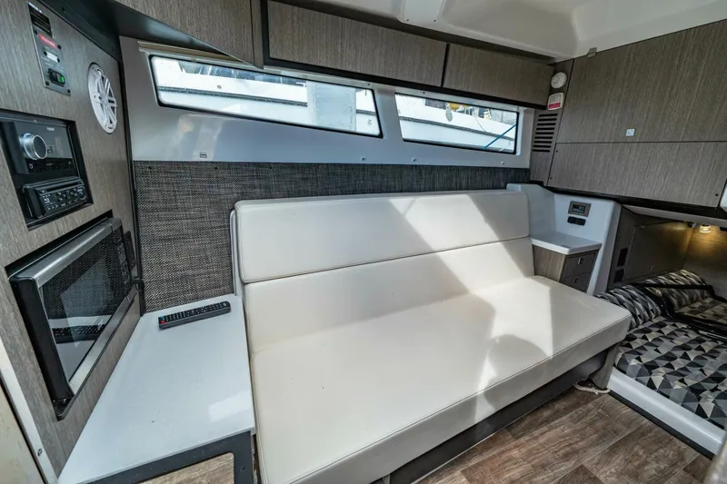 Slide: The Image of Interior of 2023 Monterey 350 Sport Yacht with modern seating and built-in appliances. - 28