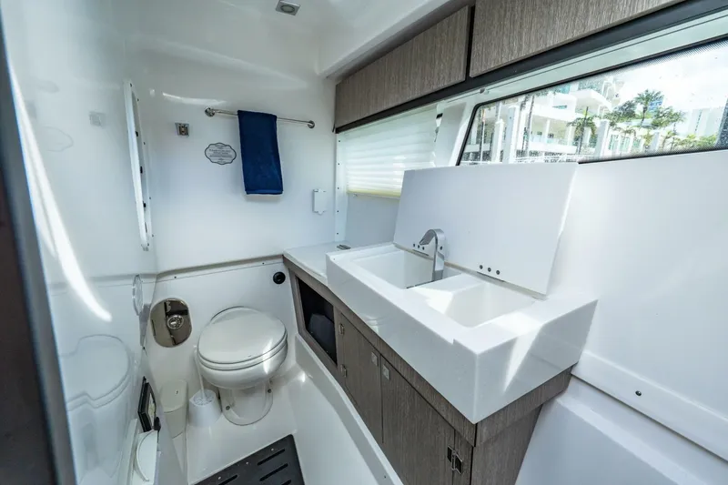 Slide: The Image of 2023 Monterey 350 Sport Yacht bathroom with modern sink, toilet, and window view. - 31