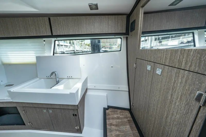 Slide: The Image of Interior of 2023 Monterey 350 Sport Yacht featuring modern cabinetry and sleek sink design. - 32