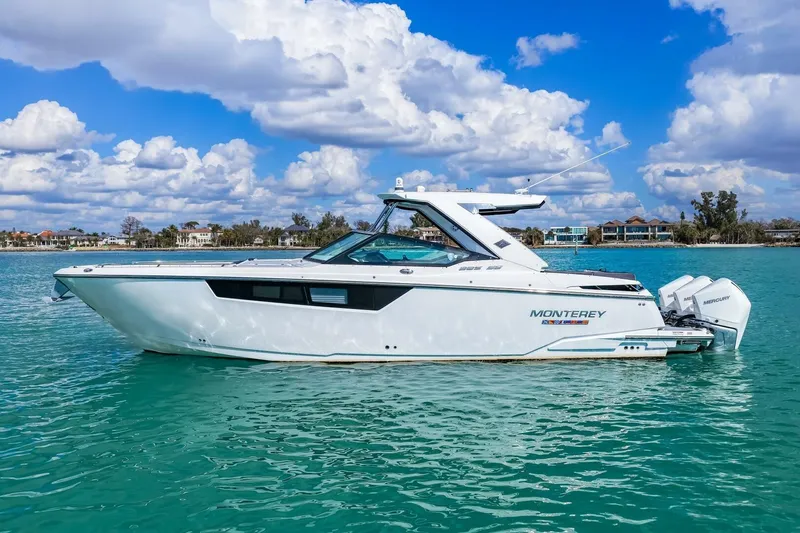 Slide: The Image of 2023 Monterey 350 Sport Yacht on turquoise water under a partly cloudy sky. - 34