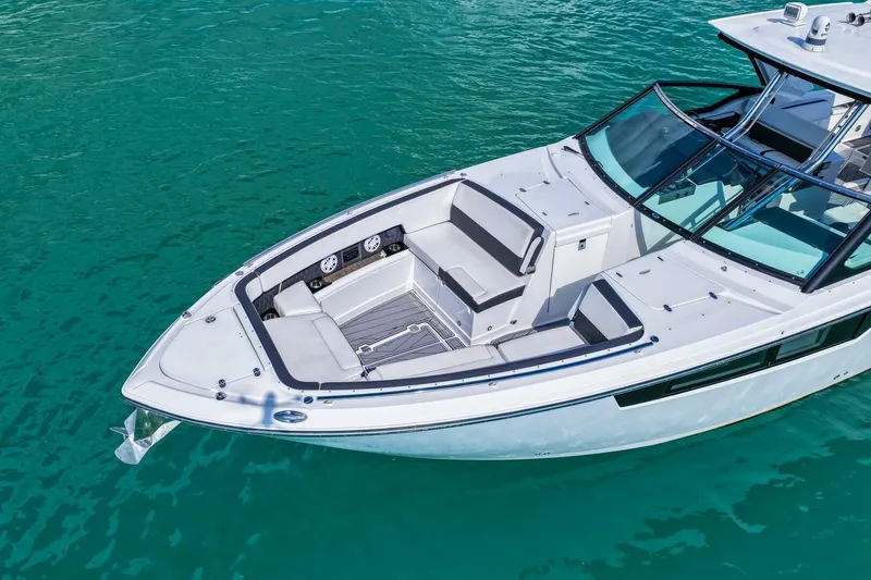 Slide: The Image of 2023 Monterey 350 Sport Yacht on turquoise water, showcasing sleek design and spacious seating. - 37