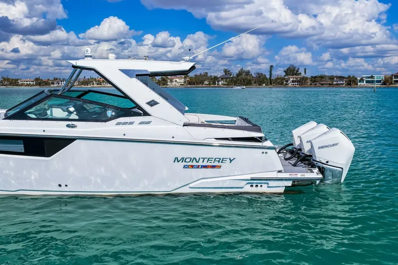 Slide: The Image of 2023 Monterey 350 Sport Yacht on turquoise water under a partly cloudy sky. - 38