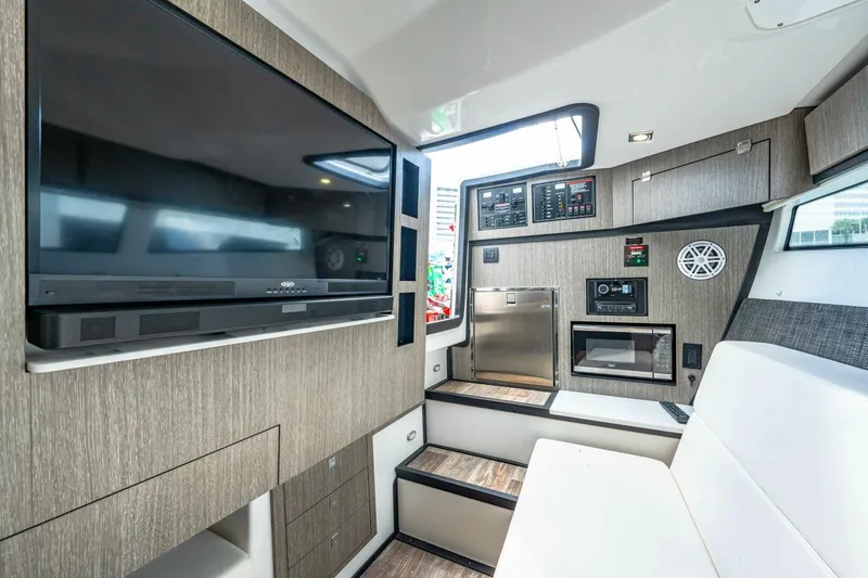 Slide: The Image of Interior of 2023 Monterey 350 Sport Yacht with modern entertainment system and seating. - 4