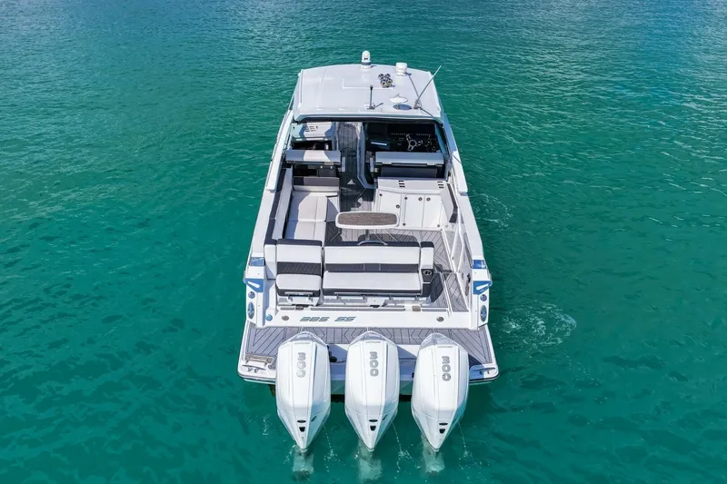 Slide: The Image of 2023 Monterey 350 Sport Yacht cruising on clear turquoise water. - 40