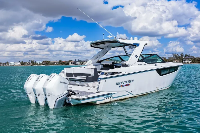Slide: The Image of 2023 Monterey 350 Sport Yacht cruising on clear blue water under a partly cloudy sky. - 42
