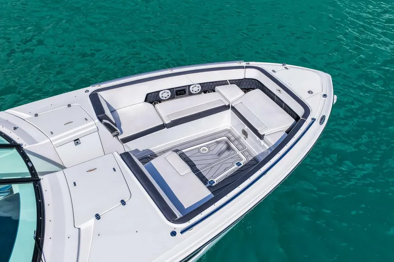 Slide: The Image of 2023 Monterey 350 Sport Yacht bow seating area on turquoise water. - 44