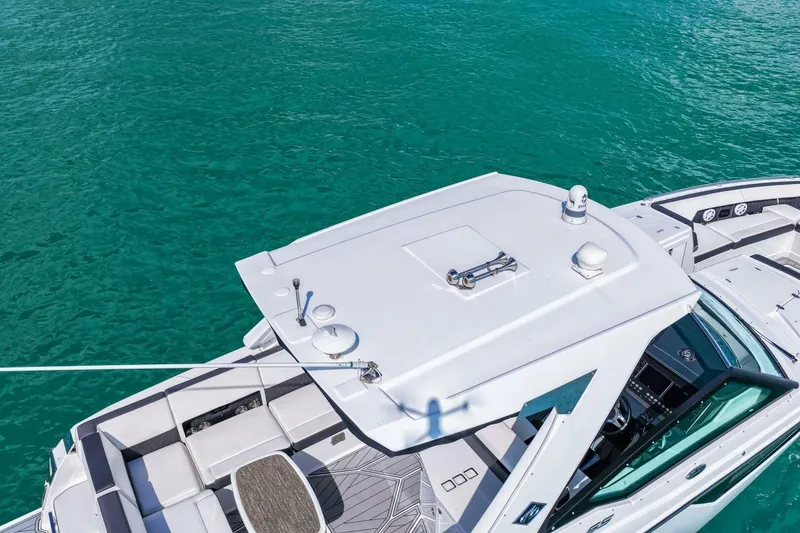 Slide: The Image of 2023 Monterey 350 Sport Yacht on turquoise water, showcasing sleek design and spacious deck. - 45
