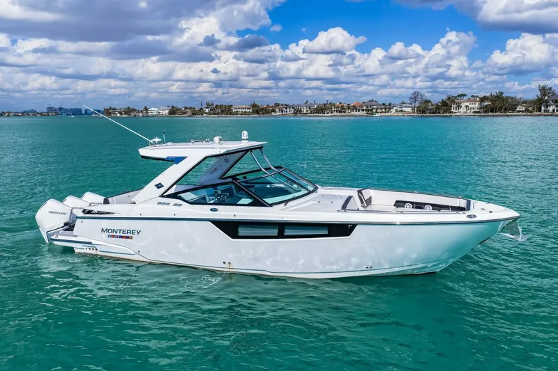 Slide: The Image of 2023 Monterey 350 Sport Yacht cruising on turquoise waters under a partly cloudy sky. - 46
