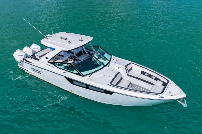 Slide: The Image of 2023 Monterey 350 Sport Yacht cruising on clear turquoise water. - 47
