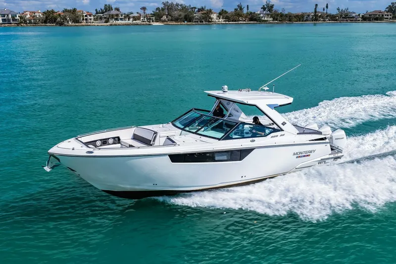 Slide: The Image of 2023 Monterey 350 Sport Yacht cruising on turquoise water, showcasing sleek design and performance. - 49