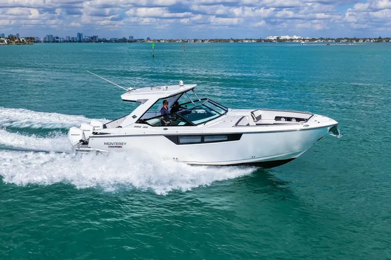 Slide: The Image of 2023 Monterey 350 Sport Yacht cruising on turquoise waters under a partly cloudy sky. - 50