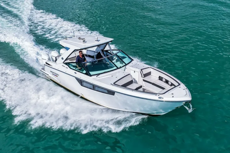 Slide: The Image of 2023 Monterey 350 Sport Yacht cruising on clear blue water. - 51