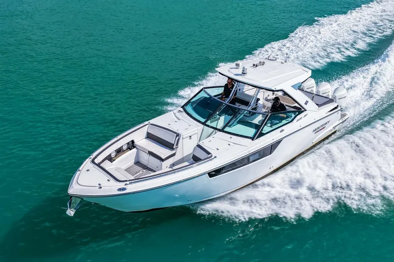 Slide: The Image of 2023 Monterey 350 Sport Yacht cruising on turquoise water. - 53