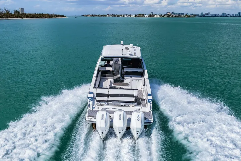 Slide: The Image of 2023 Monterey 350 Sport Yacht cruising on open water, rear view. - 54