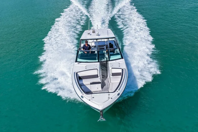 Slide: The Image of 2023 Monterey 350 Sport Yacht cruising on clear turquoise water. - 56