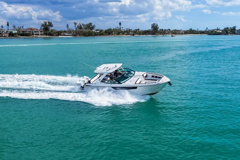 Slide: The Image of 2023 Monterey 350 Sport Yacht cruising on turquoise waters under a partly cloudy sky. - 57