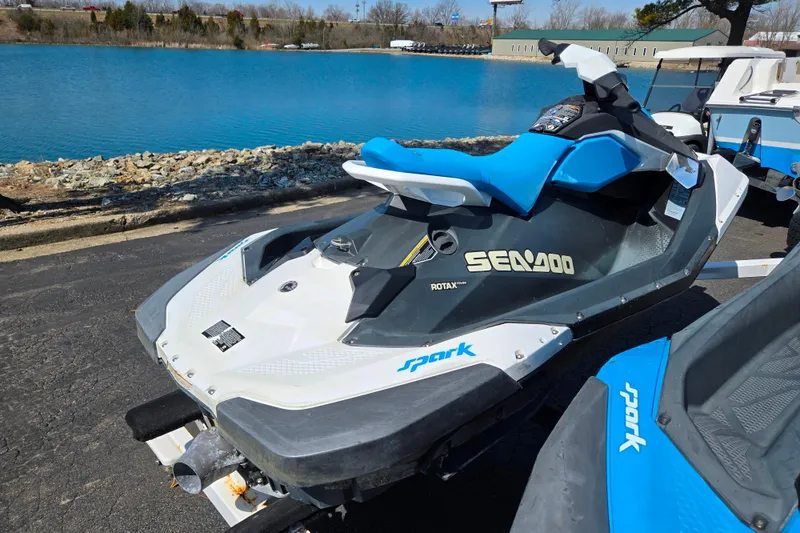 Slide: The Image of 2020 Sea-Doo Spark 2up jet ski parked by a scenic lake. - 1