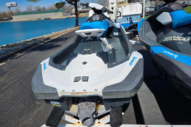 Slide: The Image of 2020 Sea-Doo Spark 2up jet ski parked near a serene blue lake. - 2