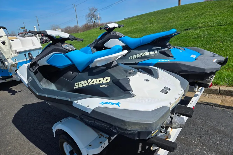 Slide: The Image of 2020 Sea-Doo Spark 2up jet skis on trailer, parked on pavement. - 3