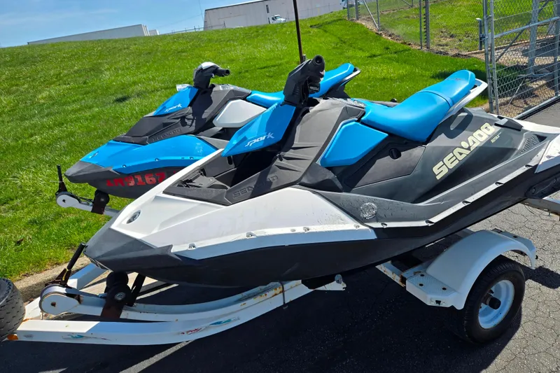 Slide: The Image of 2020 Sea-Doo Spark 2up jet skis on trailer, parked on pavement. - 4