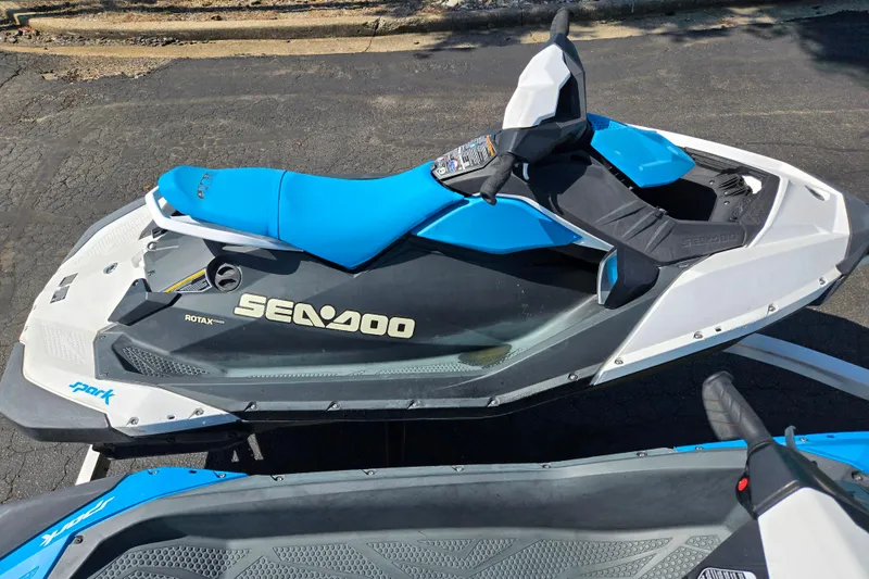 Slide: The Image of 2020 Sea-Doo Spark 2up jet ski with blue and white design on pavement. - 8