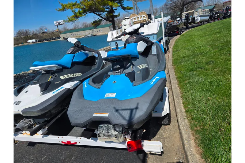 Slide: The Image of 2017 Sea-Doo Spark 2up jet skis on trailer by a lake, ready for adventure. - 2