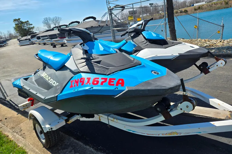 Slide: The Image of 2017 Sea-Doo Spark 2up jet skis on trailer by a lake. - 8