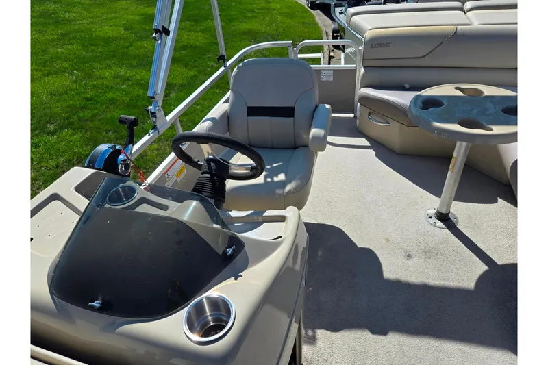 Slide: The Image of 2016 Lowe SS 190 boat interior with steering console and seating area. - 12
