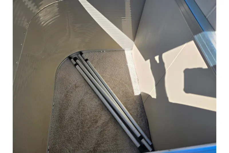 Slide: The Image of Interior of a 2016 Lowe SS 190 boat with carpeted flooring and metal poles. - 18