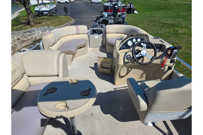 Slide: The Image of 2016 Lowe SS 190 pontoon boat interior with beige seating and steering console. - 20