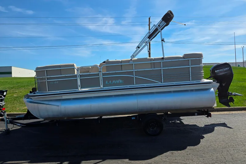 Slide: The Image of 2016 Lowe SS 190 pontoon boat on trailer, featuring Mercury outboard motor. - 4