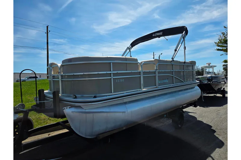 Slide: The Image of 2016 Lowe SS 190 pontoon boat on trailer under clear blue sky. - 5