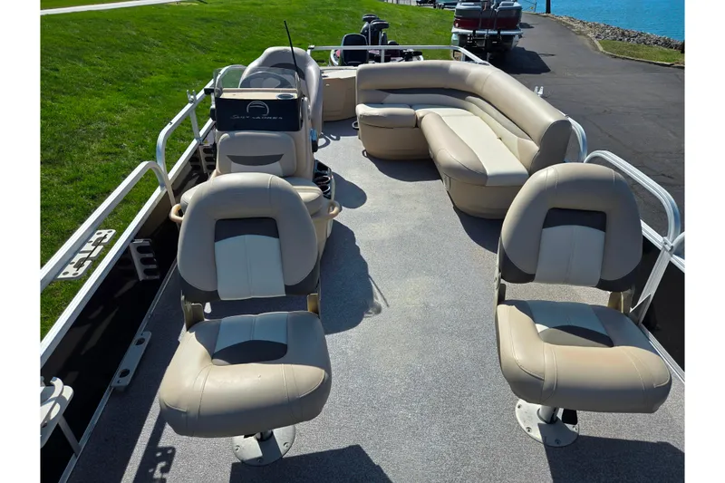 Slide: The Image of 2016 Sun Tracker Bass Buggy 18 DLX pontoon boat interior with beige seating. - 10