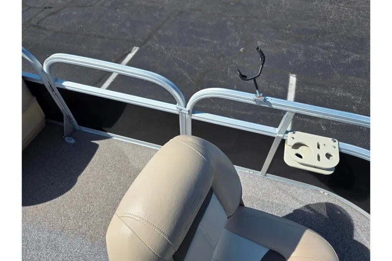 Slide: The Image of 2016 Sun Tracker Bass Buggy 18 DLX boat interior with beige seating and rod holder. - 12