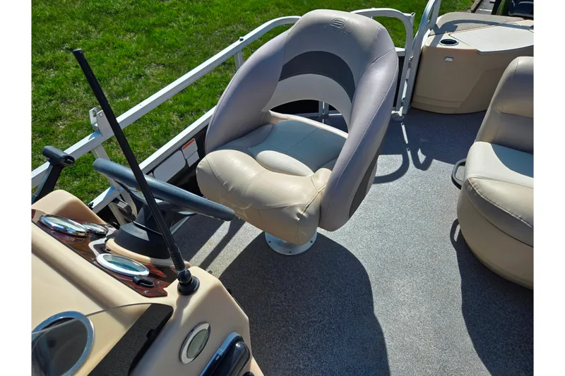 Slide: The Image of 2016 Sun Tracker Bass Buggy 18 DLX boat interior with steering wheel and seating. - 16