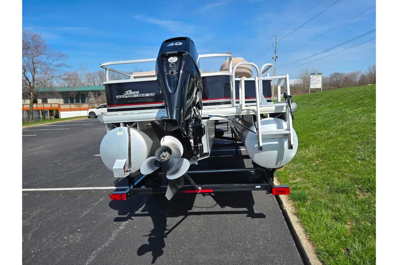 Slide: The Image of 2016 Sun Tracker Bass Buggy 18 DLX pontoon boat on trailer, rear view. - 2
