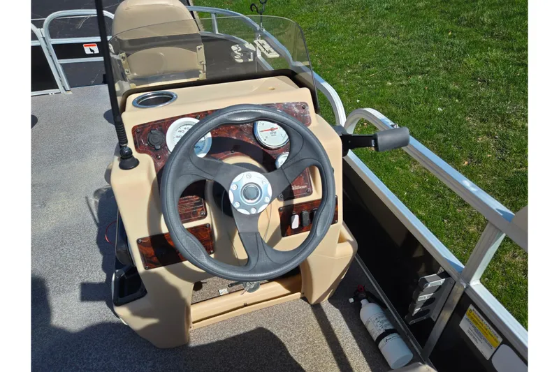 Slide: The Image of 2016 Sun Tracker Bass Buggy 18 DLX steering console with gauges and controls. - 24