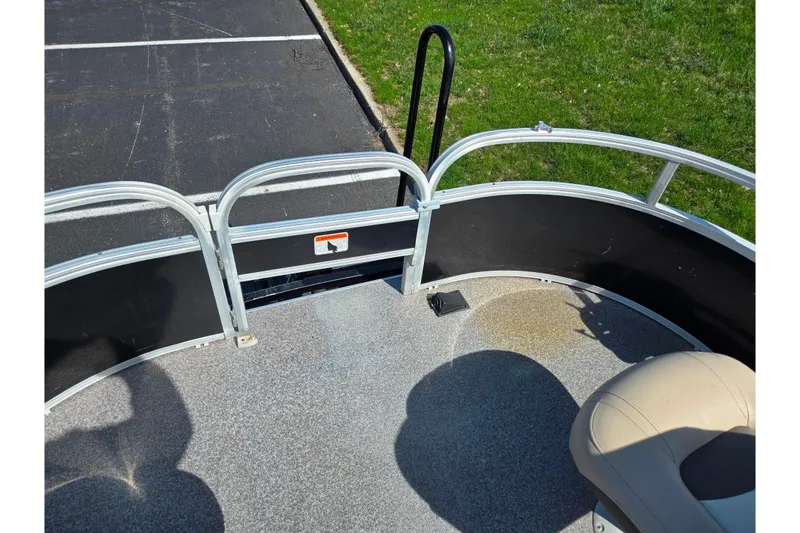 Slide: The Image of 2016 Sun Tracker Bass Buggy 18 DLX pontoon boat interior with seating and railing. - 27