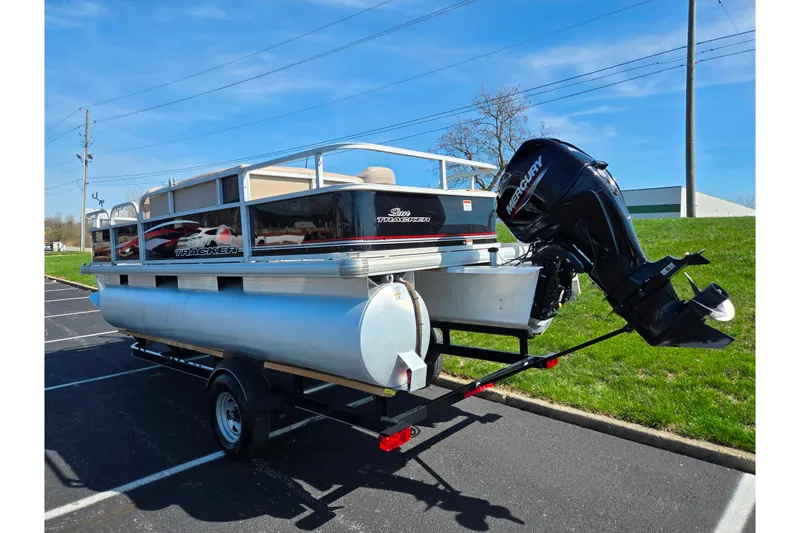 Slide: The Image of 2016 Sun Tracker Bass Buggy 18 DLX pontoon boat with Mercury outboard motor on trailer. - 3