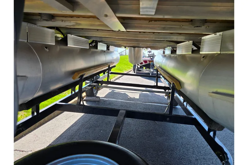 Slide: The Image of Underneath view of a 2016 Sun Tracker Bass Buggy 18 DLX pontoon boat on a trailer. - 7