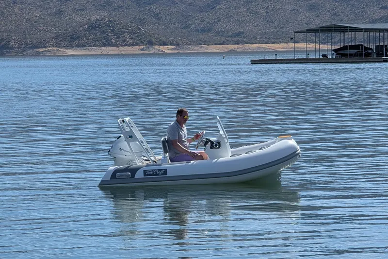 The Image of Man on 2025 Tide Craft San Juan 11 boat in calm lake waters. - 0