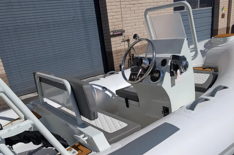 Slide: The Image of 2025 Tide Craft San Juan 11 boat interior with steering wheel and seating. - 2