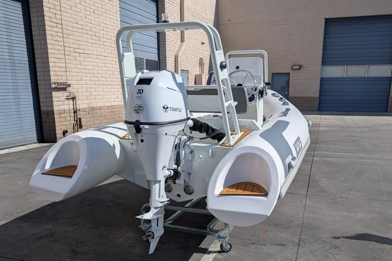 Slide: The Image of 2025 Tide Craft San Juan 11 boat with outboard motor in a warehouse setting. - 4