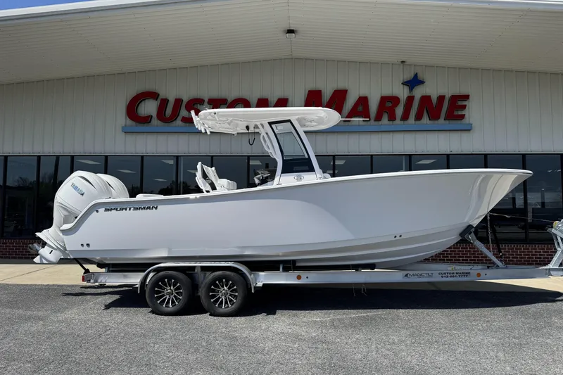 The Image of 2026 Sportsman Open 252 Center Console boat on trailer at Custom Marine dealership. - 1