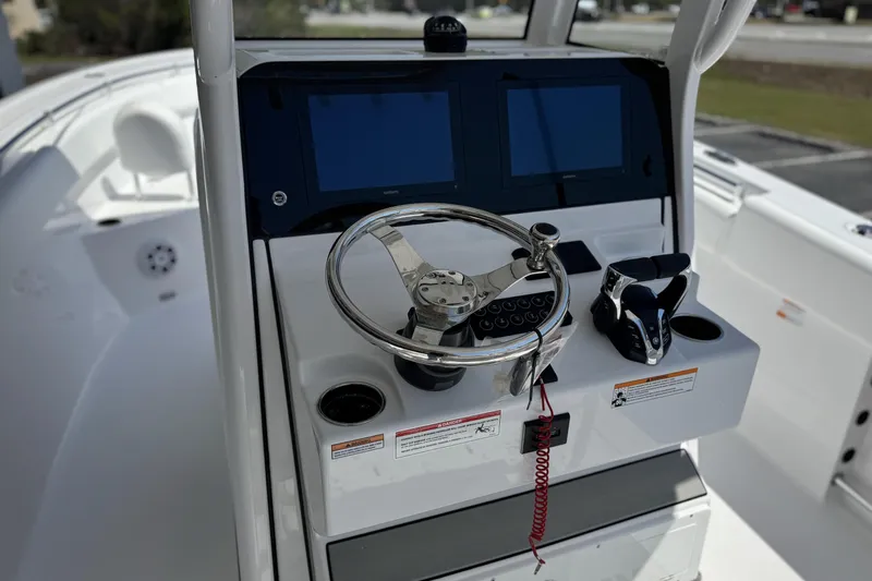 Slide: The Image of 2026 Sportsman Open 252 Center Console boat dashboard with dual screens and steering wheel. - 10