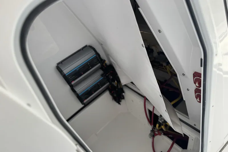 Slide: The Image of Interior view of 2026 Sportsman Open 252 Center Console boat's electrical compartment. - 12
